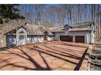 Stunning home featuring a large brick driveway and attached two-car garage at 6575 Roundhill Ct, Cumming, GA 30040