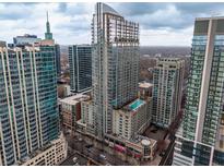 Stunning high-rise condo building with modern architecture and a rooftop pool in a vibrant city setting at 855 Peachtree Ne St # 1911, Atlanta, GA 30308