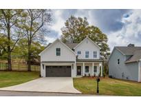 Charming two-story home with a well-manicured lawn and a two-car garage at 2949 Jefferson St, Austell, GA 30106