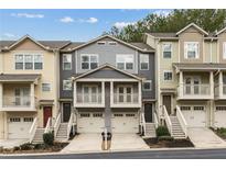 Townhome exterior with balconies, stairs, and attached garages in a neighborhood setting at 1536 Liberty Nw Pkwy, Atlanta, GA 30318
