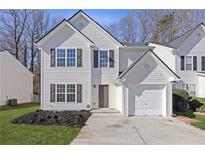 Charming two-story home with a single car garage, landscaped yard, and neutral color palette at 42 Springbottom Dr, Lawrenceville, GA 30046