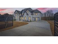 Elegant two-story home featuring a gated entry, modern design and three car garage at 928 Flanagan Mill Rd, Auburn, GA 30011