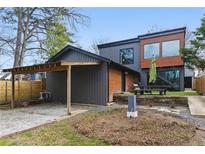 Modern home with wood and gray siding, plus a carport and outdoor dining space on the back of the house at 1742 Ridgeway Nw Ave, Atlanta, GA 30318