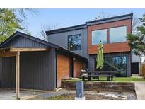 Contemporary exterior with mixed materials, including siding and wood accents, with a picnic table in the backyard at 1742 Ridgeway Nw Ave, Atlanta, GA 30318