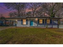Charming single-story brick home with blue shutters, freshly painted and landscaped yard at 1496 Greenwillow Dr, Conley, GA 30288
