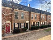 Charming townhomes featuring brick facade, black shutters, and colorful front doors at 235 Winding River Dr # B, Sandy Springs, GA 30350