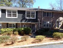 Charming townhome with brick and siding exterior, surrounded by manicured landscaping, in a well maintained community at 2401 Northlake Ct, Atlanta, GA 30345