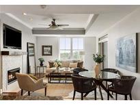 Inviting living room featuring a fireplace, ceiling fan, and lots of natural light at 2881 Peachtree Ne Rd # 702, Atlanta, GA 30305