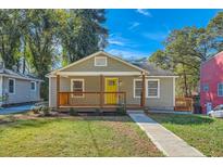 Charming single-story home featuring a welcoming front porch and a neatly manicured lawn at 1532 Pineview Sw Ter, Atlanta, GA 30311