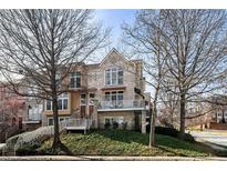 Charming multi-level brick home featuring a landscaped yard, balconies, and inviting entryway at 1354 Fernwood Ne Cir, Brookhaven, GA 30319