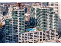 Stunning aerial view of modern condo buildings featuring a rooftop pool and city skyline at 943 Peachtree Ne St # 1108, Atlanta, GA 30309