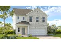 New construction two-story home featuring a brick facade, a two-car garage and a covered front entry at 1420 Windance Lake Dr, Loganville, GA 30052