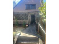 Inviting home entrance with black trim, decorative latticework, and well-lit front steps at 1483 Hardee Ne St, Atlanta, GA 30307