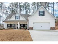 Beautiful, white two-story home with a well-manicured lawn and a two-car garage at 6045 Crowley Dr, Douglasville, GA 30135