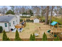 Spacious backyard features a deck, patio, play area, shed, and a well-maintained lawn, perfect for outdoor activities and relaxation at 1060 Mclinden Se Ave, Smyrna, GA 30080