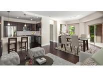 Open living space featuring kitchen with stainless steel appliances and dining area with access to the balcony at 200 River Vista Dr # 205, Atlanta, GA 30339