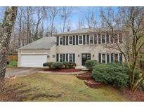 Charming two-story brick home with attached two-car garage and manicured front yard landscaping at 2795 Kakki Ct, Marietta, GA 30062