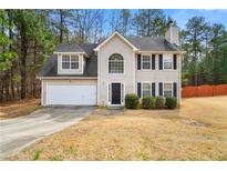 Charming two-story home featuring a two-car garage, classic black shutters, and a well-manicured lawn at 3999 Craggy Perch, Douglasville, GA 30135