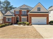 Charming two-story brick home featuring a manicured lawn and a two-car garage in a suburban setting at 2986 Nestle Creek Dr, Marietta, GA 30062