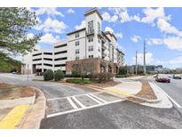 Attractive apartment building exterior with balconies, street views, and adjacent parking garage at 901 Abernathy Ne Rd # 3220, Sandy Springs, GA 30328