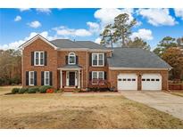 Beautiful two story brick home with a two car garage and manicured lawn at 2607 Westchester Se Pkwy, Conyers, GA 30013