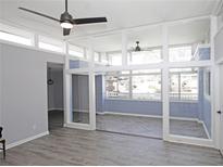 Open-concept living room featuring gray walls, hardwood floors, and expansive windows at 346 Carpenter Drive Ne Dr # 32, Sandy Springs, GA 30328