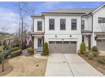 Charming two-story townhome with a two-car garage, neat landscaping, and an inviting covered entrance at 347 Bailey Walk, Alpharetta, GA 30009