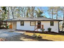 Charming single-story home with a white brick exterior and covered parking at 3113 Bellgreen Way, Decatur, GA 30032