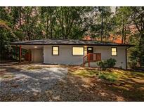 Charming single-story home featuring a carport, landscaped front yard, and freshly painted exterior at 3113 Bellgreen Way, Decatur, GA 30032