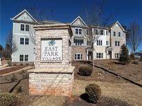 East Park Village community sign in front of newly constructed townhomes under a blue sky at 3352 Cranston Ln, Kennesaw, GA 30144