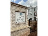 East Park Village entrance sign with brick surround near fenced townhomes on a sunny day at 3352 Cranston Ln, Kennesaw, GA 30144