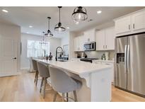 Bright, modern kitchen features a large island with seating and stainless steel appliances at 3352 Cranston Ln, Kennesaw, GA 30144