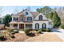 Beautiful two-story home with stone accents, covered porch, manicured landscaping, and a two-car garage at 4978 Millwood Dr, Canton, GA 30114