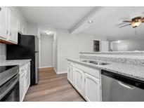 Updated kitchen featuring stainless steel appliances, granite countertops and white cabinetry at 5555 Clover Rise Ln, Norcross, GA 30093