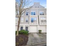 Charming townhome with attached garage and well-maintained landscaping offers curb appeal and convenience at 1204 Village Se Ct, Atlanta, GA 30316