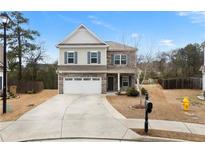 Charming two-story home featuring a two-car garage and a mix of stone and siding at 72 Summer Nw Pl, Cartersville, GA 30121