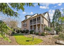 Elegant brick home with a screened porch, balcony, and manicured landscaping at 1059 Hedge Rose Ne Ct, Atlanta, GA 30324