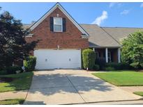 Charming brick home with a two-car garage and well-maintained landscaping at 352 Lauren Ln, Woodstock, GA 30188