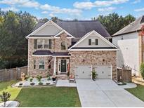 Beautiful two-story brick home with a well-maintained front yard and a two-car garage at 3865 Brookhollow Dr, Douglasville, GA 30135