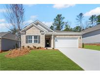 Charming one-story home with brick facade, manicured lawn, and attached two-car garage at 147 Park Lane Ln, Fairburn, GA 30213