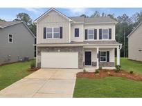 Charming two-story home with stone accents, an attached garage, and a well-manicured lawn at 640 Blackshear Trl, Temple, GA 30179