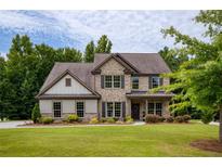 Inviting two-story brick home with lush lawn and manicured landscaping at 200 Bexley Pkwy, Tyrone, GA 30290