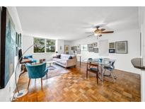 Bright living room featuring hardwood floors, a ceiling fan, comfortable seating, and a dining area at 2965 Pharr Court South Nw # 712, Atlanta, GA 30305