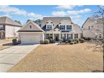 Charming two-story home with a well-manicured lawn, attached garage, and inviting front entrance at 2207 Derbyshire Sw Dr, Marietta, GA 30064