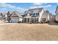 Charming two-story home featuring an attached garage and a well-manicured front yard at 2207 Derbyshire Sw Dr, Marietta, GA 30064