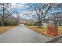 Charming two-story home with a brick mailbox, spacious driveway, and a well-manicured lawn at 381 Gates Mil Dr, Lawrenceville, GA 30045