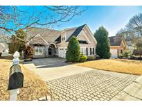 Charming two-story home featuring stone accents, a well-manicured lawn, and a spacious driveway with a mailbox at 203 Lenox Dr, Peachtree City, GA 30269