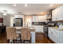 Modern kitchen featuring stainless steel appliances, white cabinetry, and granite countertops at 3224 Canary Ct, Decatur, GA 30032