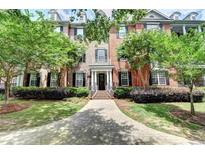 Inviting brick home featuring meticulously manicured landscaping and a charming walkway that enhances its curb appeal at 4850 Ivy Ridge Se Dr # 205, Atlanta, GA 30339