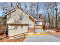 Charming home with a painted, wood trimmed porch, new wooden stairs and new parking area at 653 Inland Way, Lilburn, GA 30047